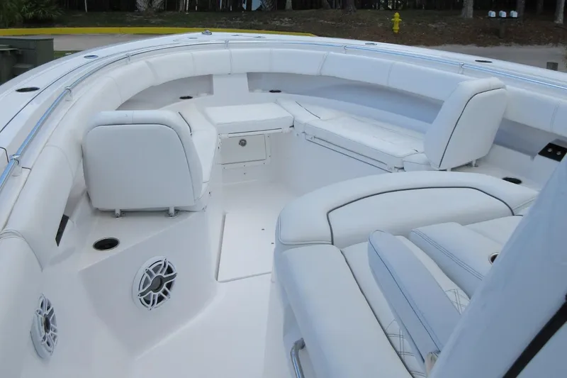 Slide: The Image of 2021 Sportsman Open 352 Center Console boat interior with white seating and speakers. - 14