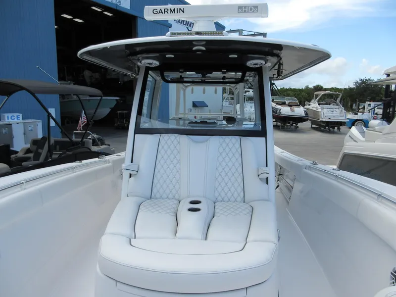 Slide: The Image of 2021 Sportsman Open 352 Center Console boat with white seating and Garmin equipment. - 17