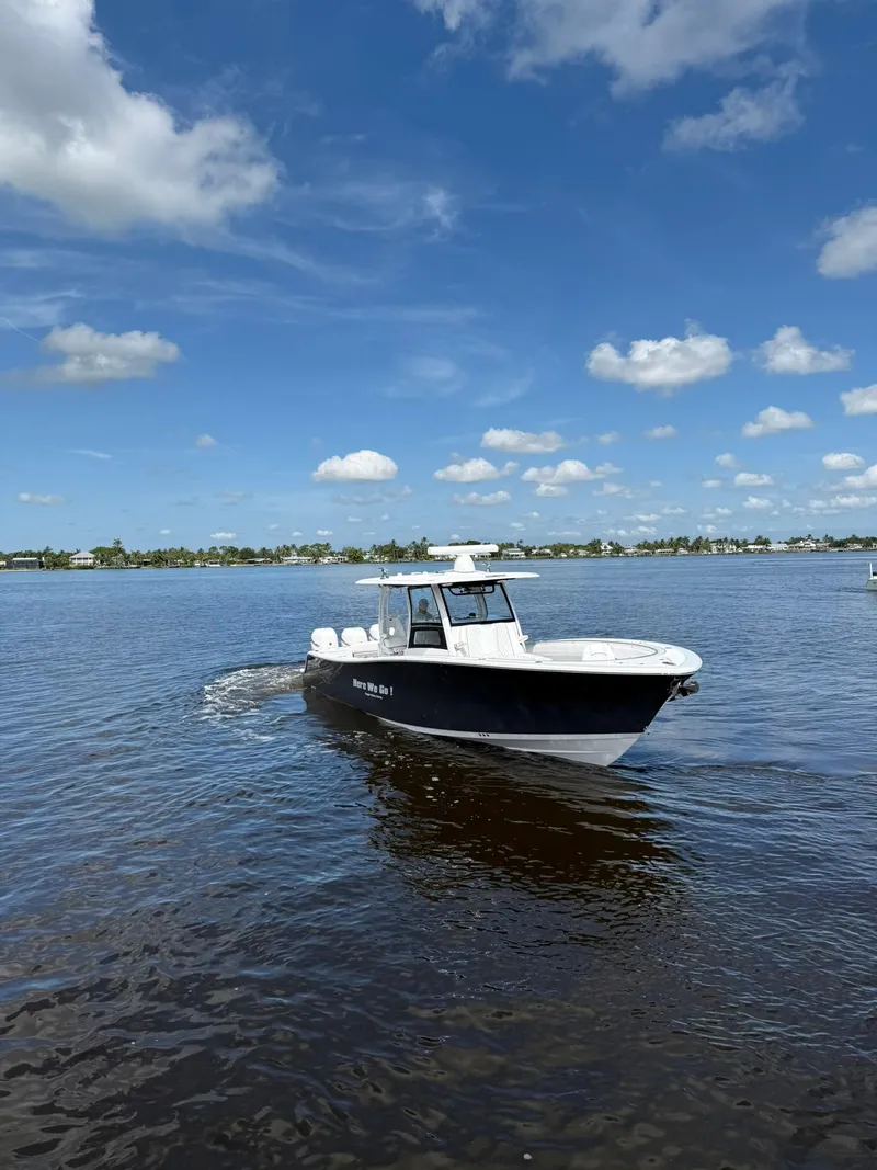 Slide: The Image of 2021 Sportsman Open 352 Center Console boat cruising on a sunny day. - 2