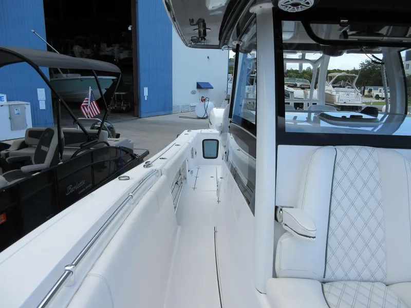 Slide: The Image of 2021 Sportsman Open 352 Center Console boat at marina, featuring sleek design and comfortable seating. - 21