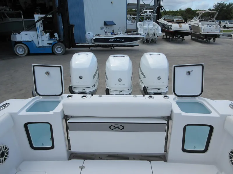 Slide: The Image of 2021 Sportsman Open 352 Center Console with triple Mercury outboard engines at a marina. - 23