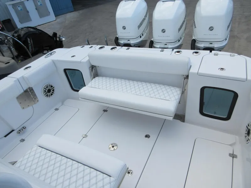 Slide: The Image of 2021 Sportsman Open 352 Center Console boat interior with seating and Mercury engines. - 24