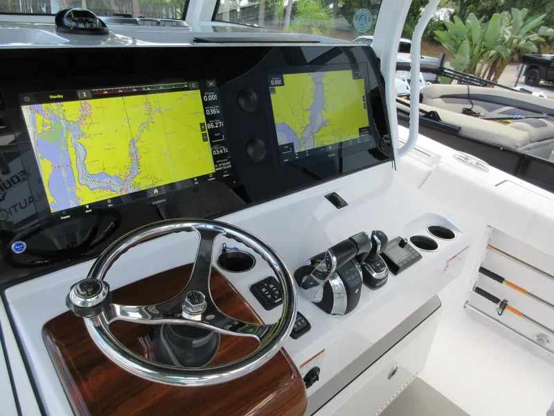 Slide: The Image of 2021 Sportsman Open 352 Center Console helm with dual navigation screens and steering wheel. - 28