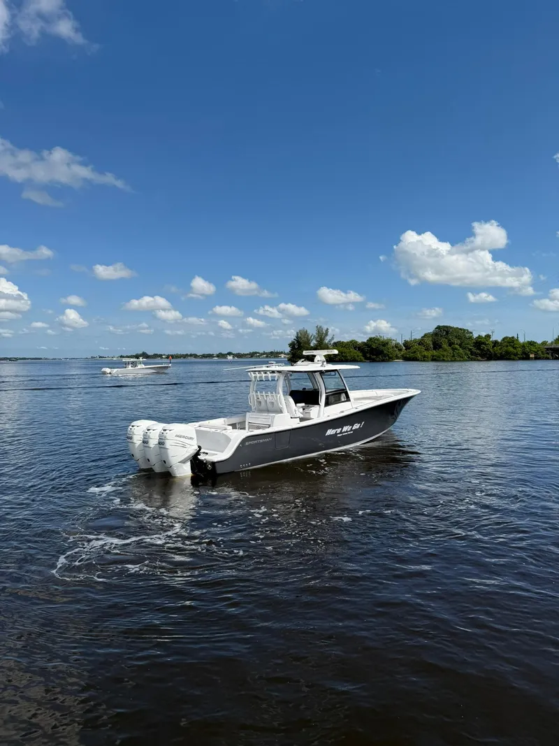 Slide: The Image of 2021 Sportsman Open 352 Center Console boat on calm water under blue sky. - 3