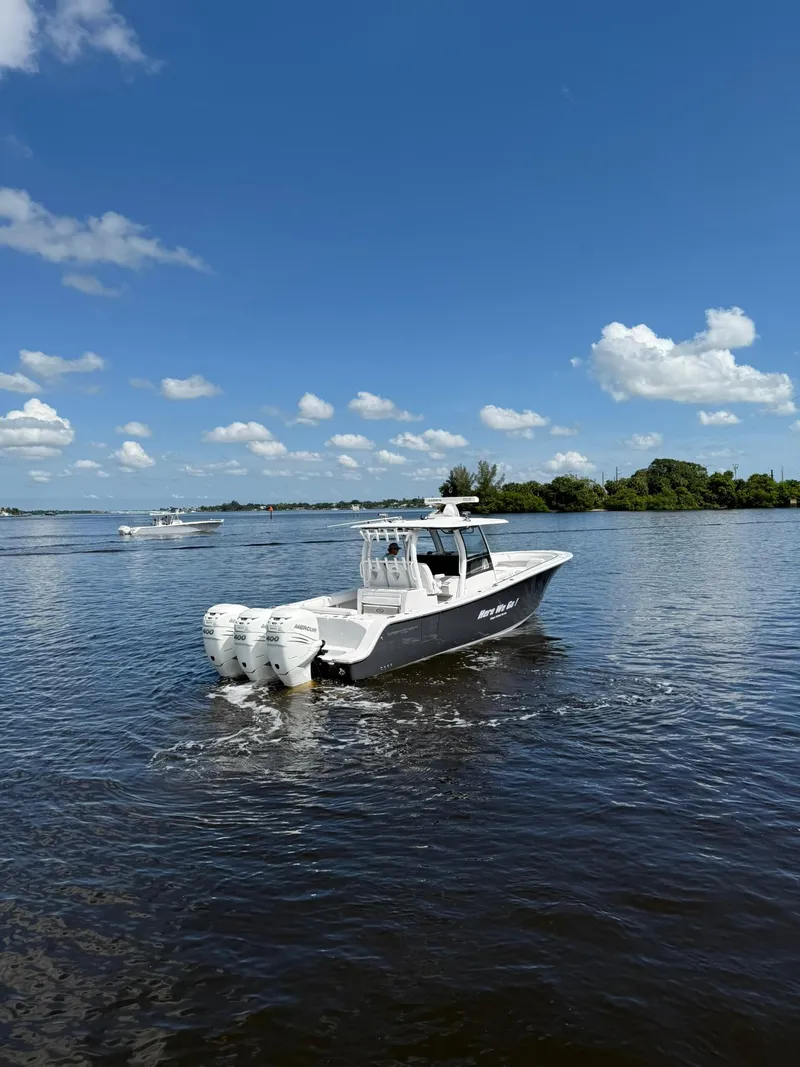 Slide: The Image of 2021 Sportsman Open 352 Center Console boat cruising on a sunny day. - 7