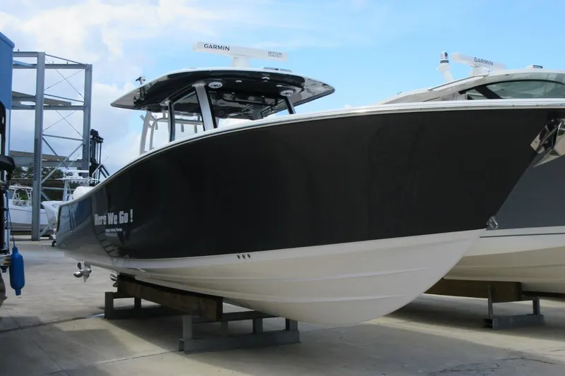 Slide: The Image of 2021 Sportsman Open 352 Center Console boat on display at a marina. - 8