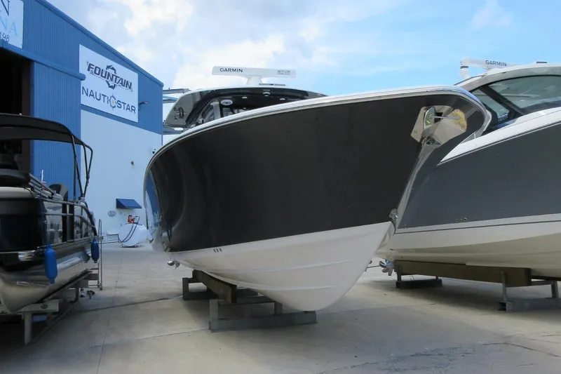 Slide: The Image of 2021 Sportsman Open 352 Center Console boat displayed at a marina. - 9