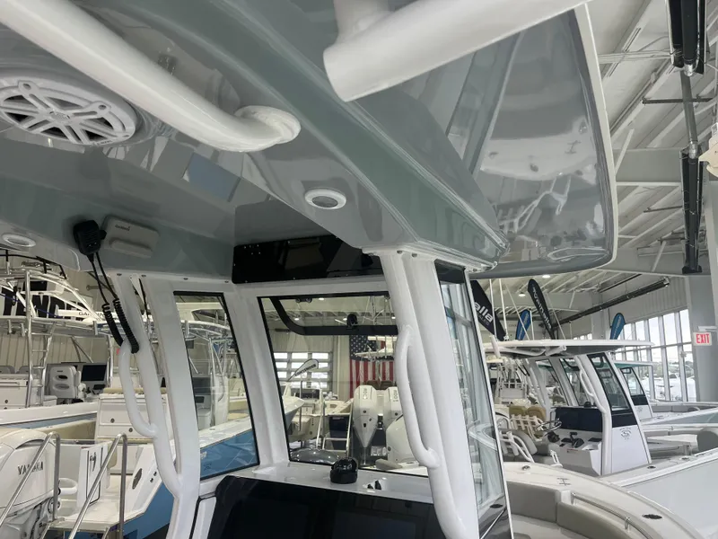 Slide: The Image of 2025 Sportsman Open 212 Center Console boat interior in showroom. - 14