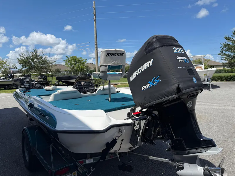 Slide: The Image of 1995 Stratos 201XL boat with Mercury Pro XS engine, parked outdoors. - 11