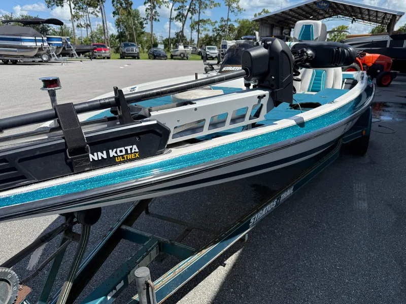 Slide: The Image of 1995 Stratos 201XL boat with Minn Kota Ultrex motor, parked outdoors. - 3