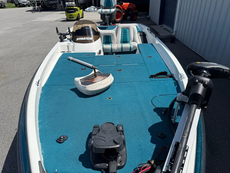 Slide: The Image of 1995 Stratos 201XL boat with blue deck, steering console, and fishing equipment. - 6
