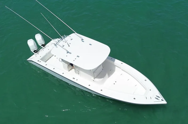 Slide: The Image of 2006 Venture 34 Open boat with dual engines on clear water. - 10