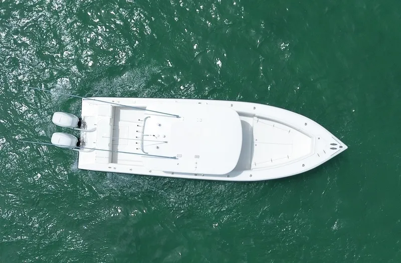 Slide: The Image of Aerial view of 2006 Venture 34 Open boat on green water. - 14