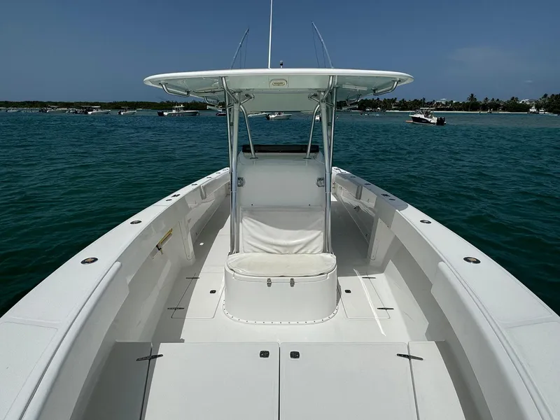 Slide: The Image of 2006 Venture 34 Open boat on calm water, featuring spacious deck and T-top. - 15