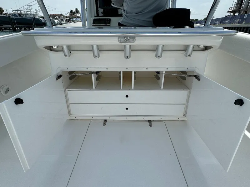 Slide: The Image of 2006 Venture 34 Open boat storage compartment with open doors and organized shelves. - 17