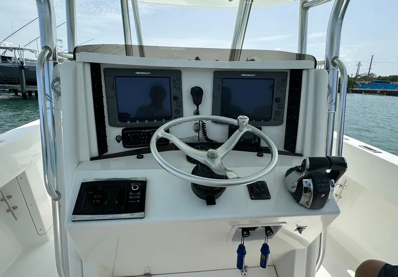 Slide: The Image of 2006 Venture 34 Open boat helm with dual screens and steering wheel. - 2