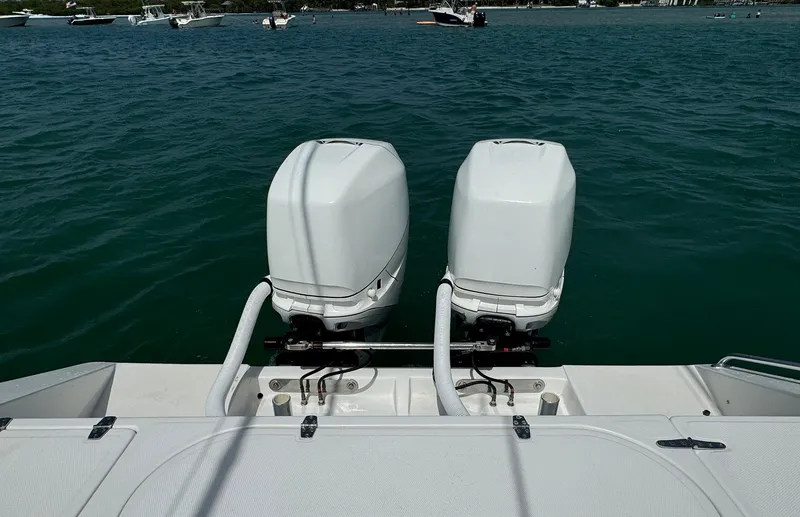Slide: The Image of Twin outboard motors on a 2006 Venture 34 Open boat in open water. - 20