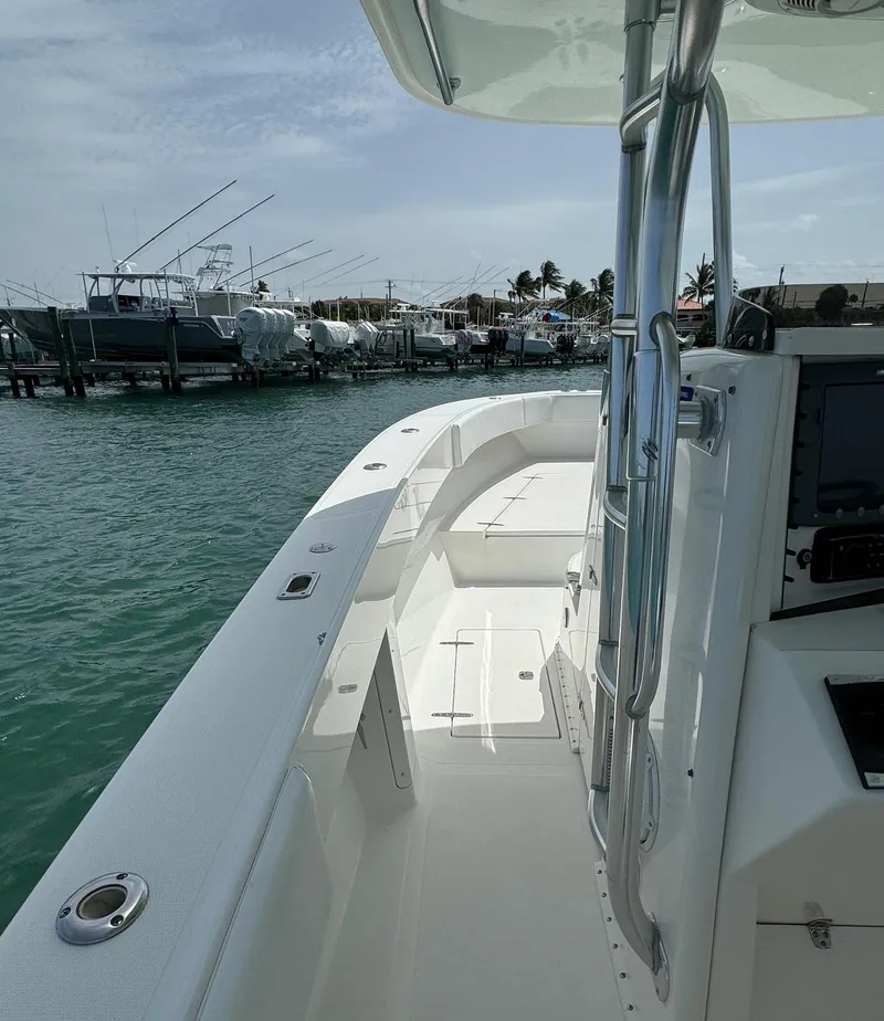 Slide: The Image of 2006 Venture 34 Open boat docked, showcasing sleek design and spacious deck. - 21
