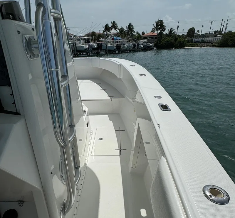Slide: The Image of 2006 Venture 34 Open boat deck with stainless steel railings, docked near palm trees. - 23