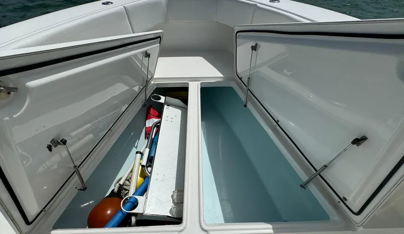 Slide: The Image of Open storage compartments on a 2006 Venture 34 Open boat, showing organized equipment. - 24
