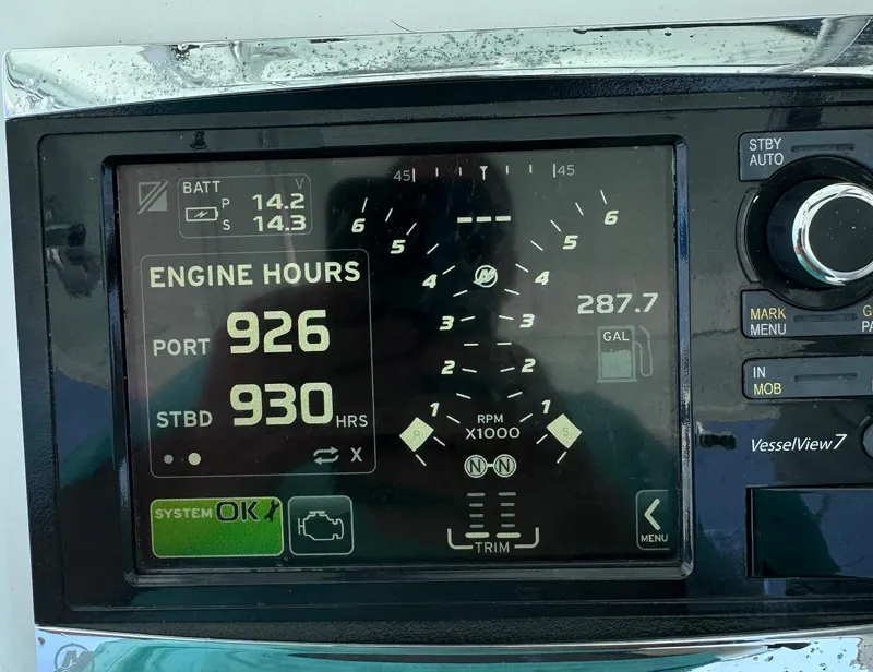 Slide: The Image of Boat dashboard display showing engine hours and battery voltage on a 2006 Venture 34 Open. - 25