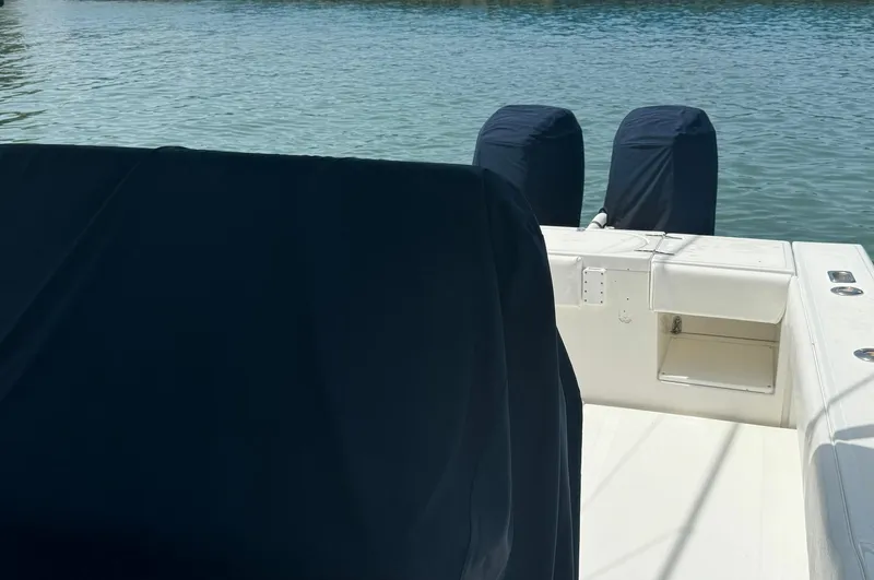 Slide: The Image of 2006 Venture 34 Open boat with covered engines on calm water. - 27