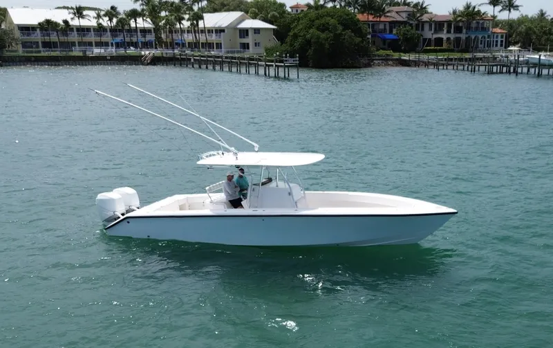 Slide: The Image of 2006 Venture 34 Open boat cruising on a sunny day near waterfront homes. - 4