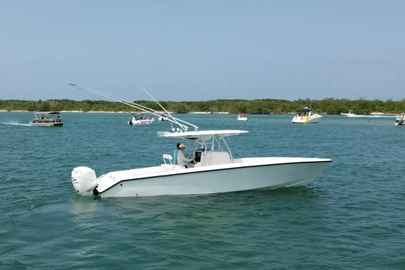 Slide: The Image of 2006 Venture 34 Open boat cruising on a sunny day in clear waters. - 5