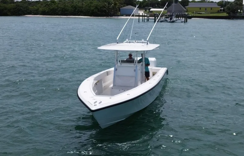 Slide: The Image of 2006 Venture 34 Open boat cruising on calm waters near a dock. - 7