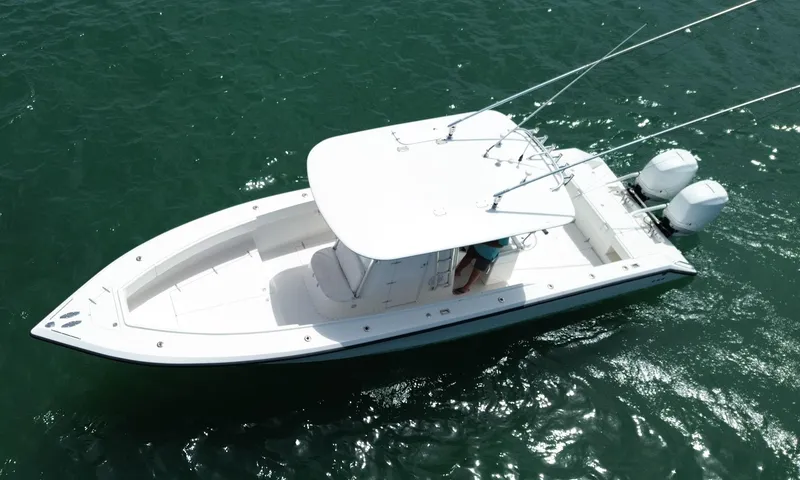 Slide: The Image of 2006 Venture 34 Open boat on water, aerial view, white hull, dual engines. - 8