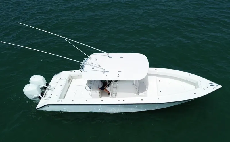 Slide: The Image of 2006 Venture 34 Open boat on water, aerial view, white hull, dual engines. - 9