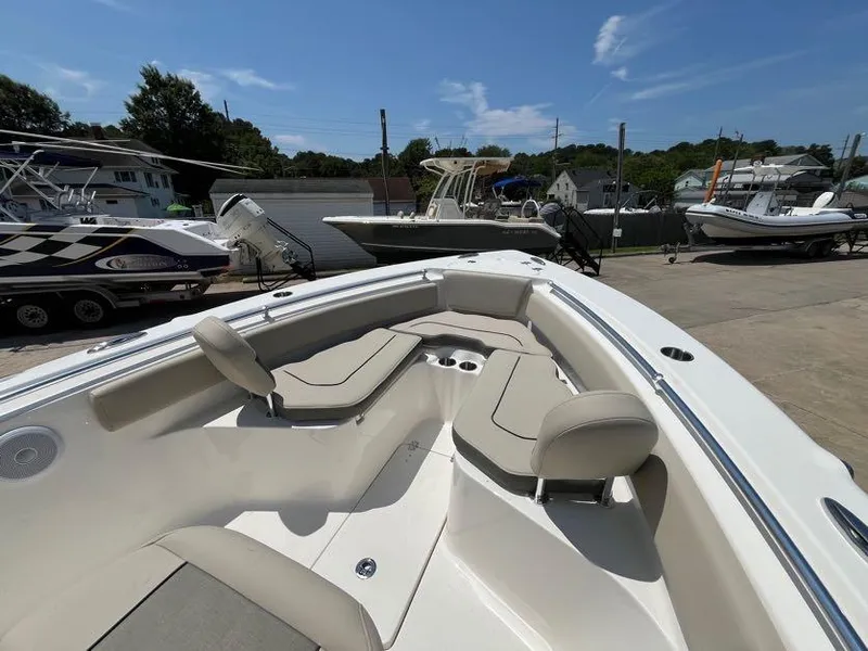 Slide: The Image of 2025 Key West 239 FS boat interior with cushioned seating and cup holders. - 10