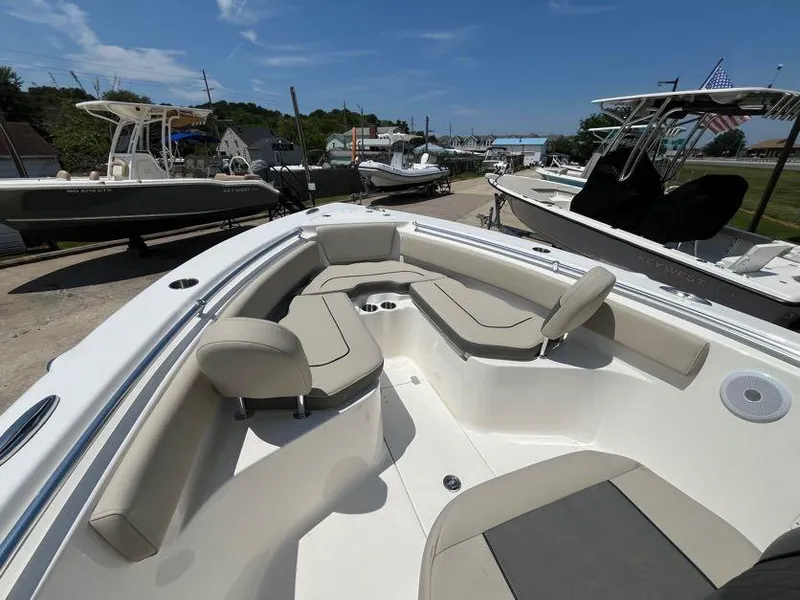 Slide: The Image of 2025 Key West 239 FS boat with spacious seating and sleek design, docked under clear skies. - 11