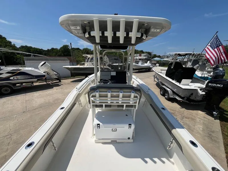 Slide: The Image of 2025 Key West 239 FS boat with T-top and rod holders, parked outdoors. - 12