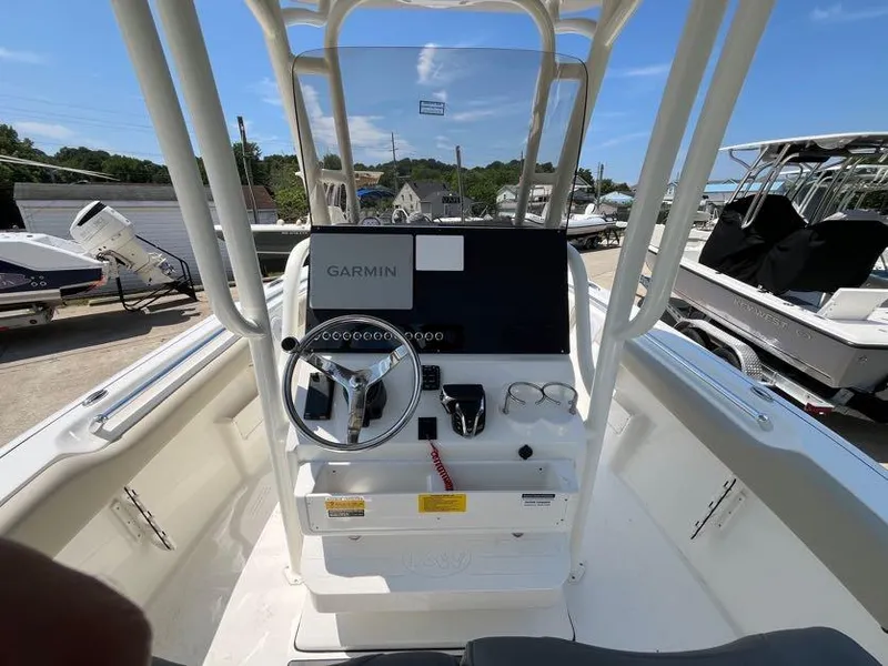 Slide: The Image of 2025 Key West 239 FS boat console with Garmin navigation system, steering wheel, and controls. - 13