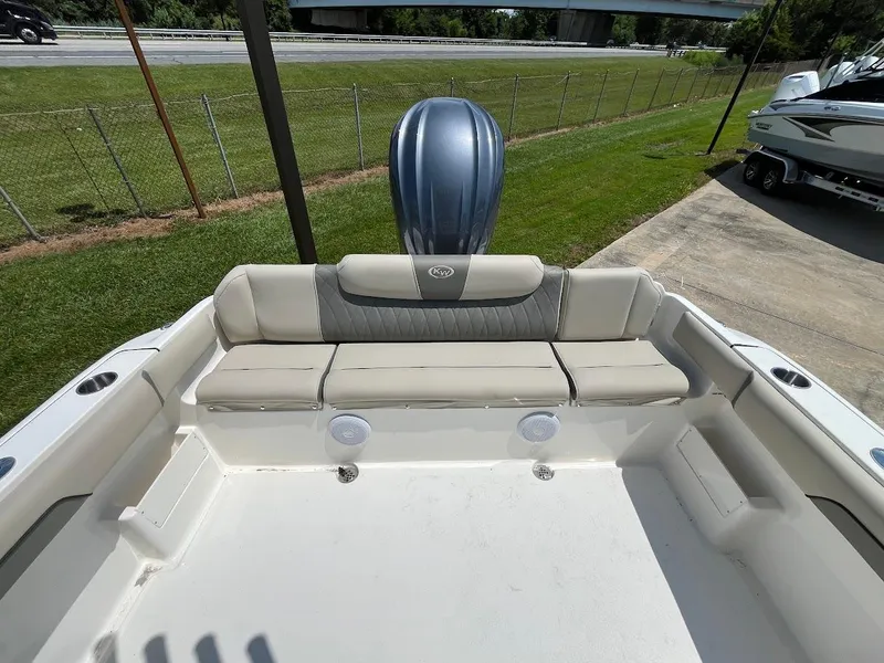 Slide: The Image of 2025 Key West 239 FS boat interior with cushioned seating and outboard motor. - 14
