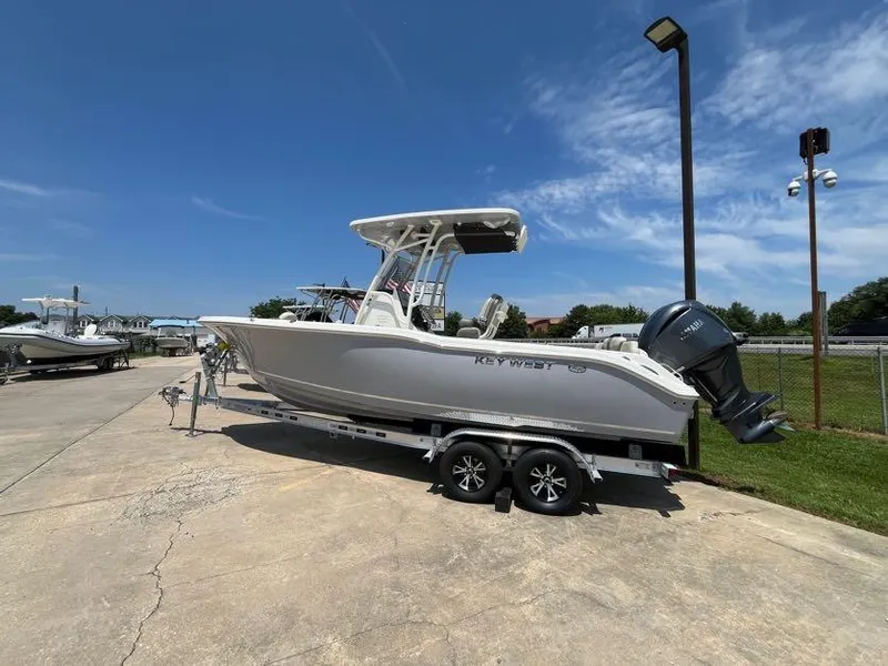Slide: The Image of 2025 Key West 239 FS boat on trailer under clear blue sky. - 4