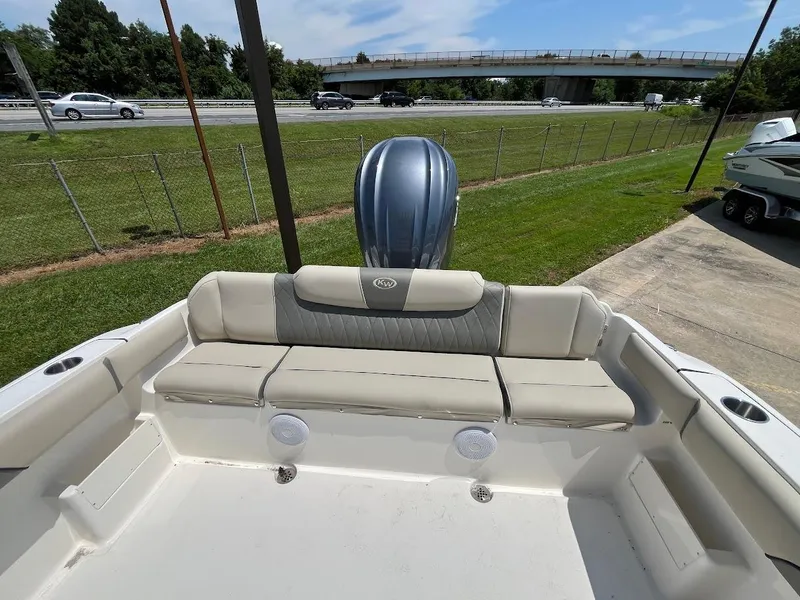 Slide: The Image of 2025 Key West 239 FS boat interior with cushioned seating and outboard motor. - 5