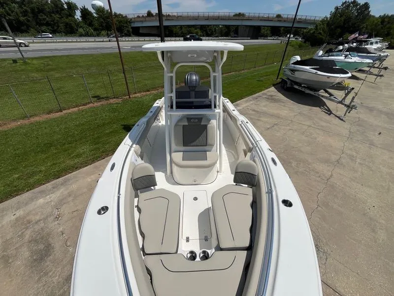 Slide: The Image of 2025 Key West 239 FS boat with spacious seating and sleek design, parked outdoors. - 6