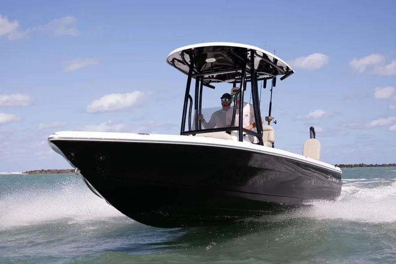 Slide: The Image of 2025 Savannah 210X boat on trailer in parking lot, under clear sky. - 2