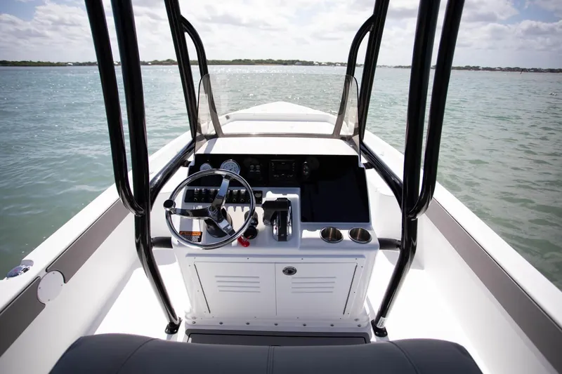 Slide: The Image of 2025 Savannah 210X boat interior with quilted seats and steering wheel. - 7