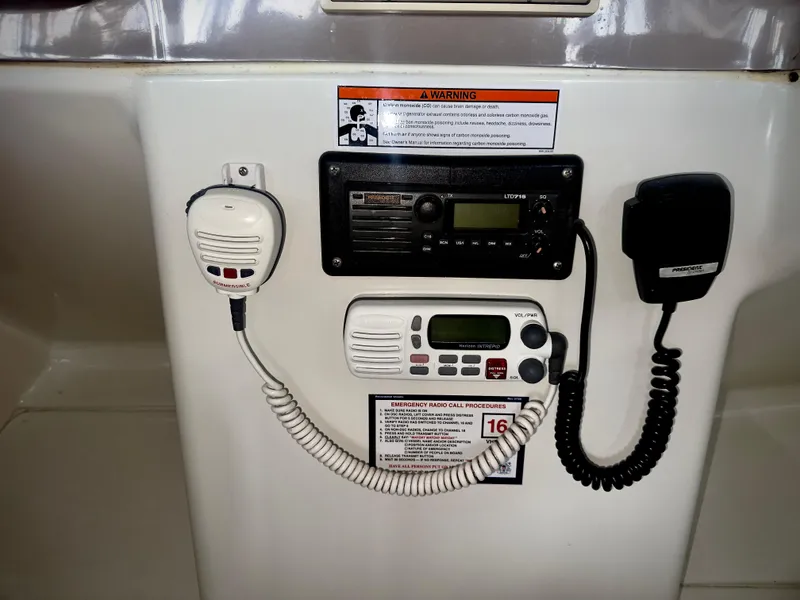 Slide: The Image of 1997 Carver 350 Mariner radio equipment with warning labels and communication devices. - 10