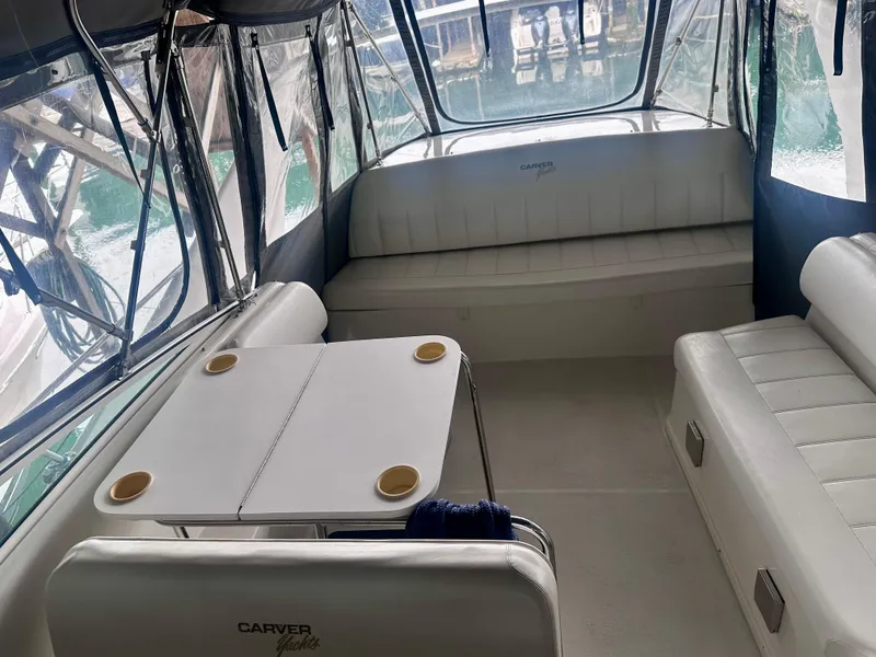 Slide: The Image of Interior of a 1997 Carver 350 Mariner yacht with seating and table. - 14