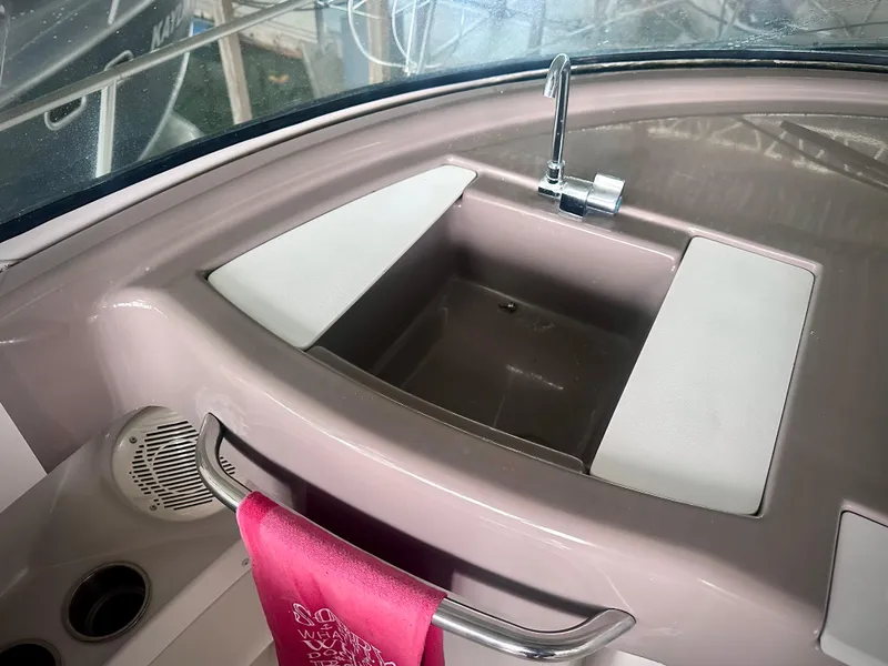 Slide: The Image of 1997 Carver 350 Mariner boat sink with faucet and pink towel. - 15