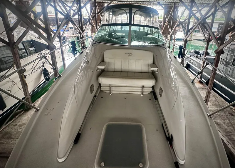 Slide: The Image of 1997 Carver 350 Mariner boat interior with seating, docked in a covered marina. - 18