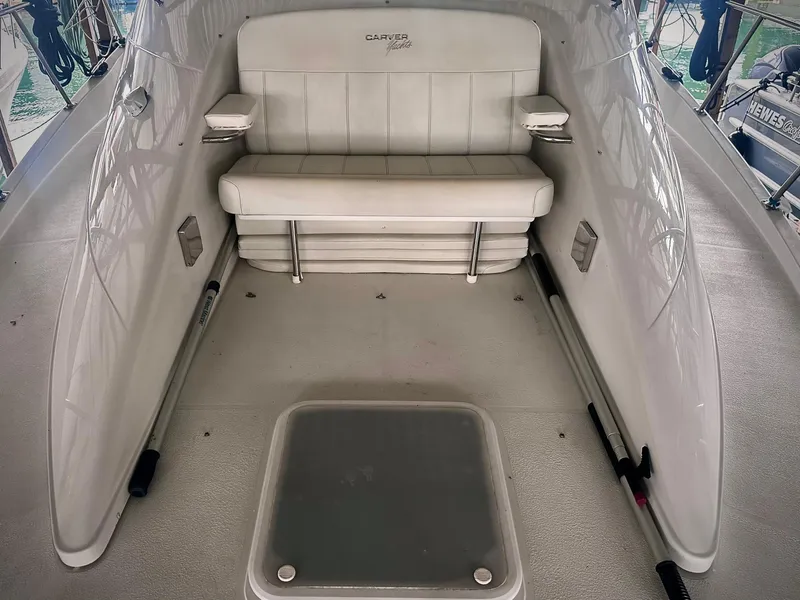 Slide: The Image of 1997 Carver 350 Mariner boat interior with white seating and storage compartment. - 19