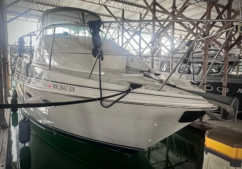 Slide: The Image of 1997 Carver 350 Mariner yacht docked in a covered marina. - 2