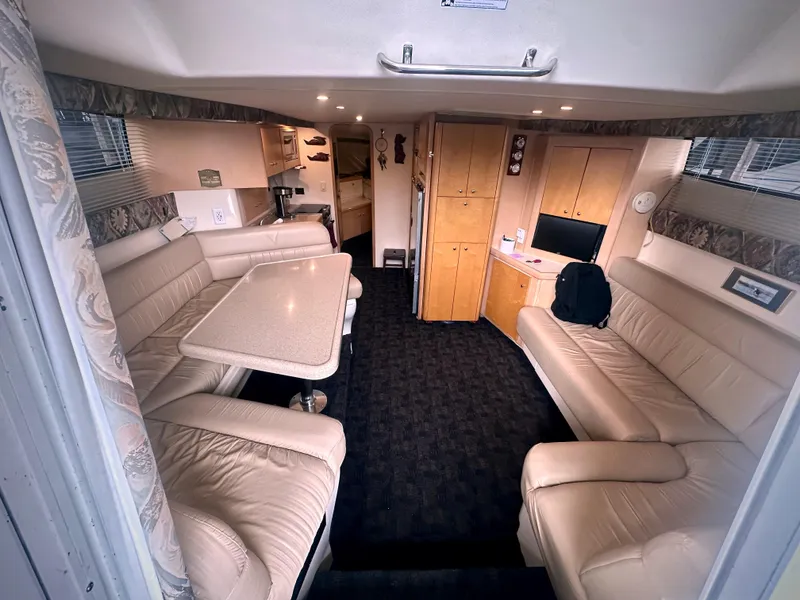 Slide: The Image of Interior of 1997 Carver 350 Mariner yacht with beige seating and dining area. - 21
