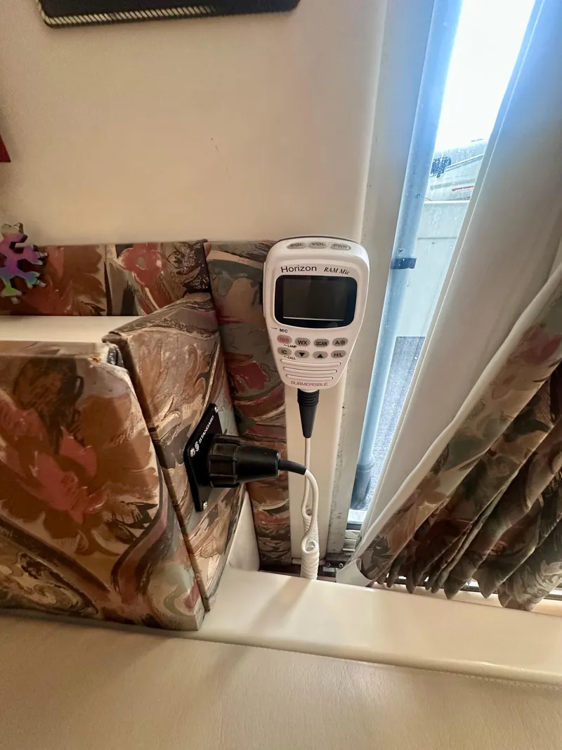 Slide: The Image of Radio device inside 1997 Carver 350 Mariner boat, near floral-patterned upholstery and window. - 23