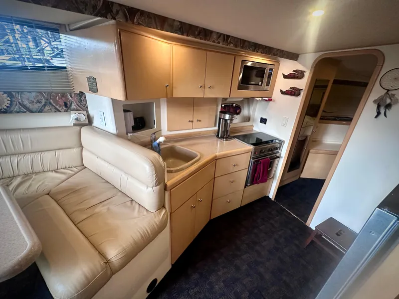 Slide: The Image of Interior of 1997 Carver 350 Mariner yacht with kitchen and seating area. - 24